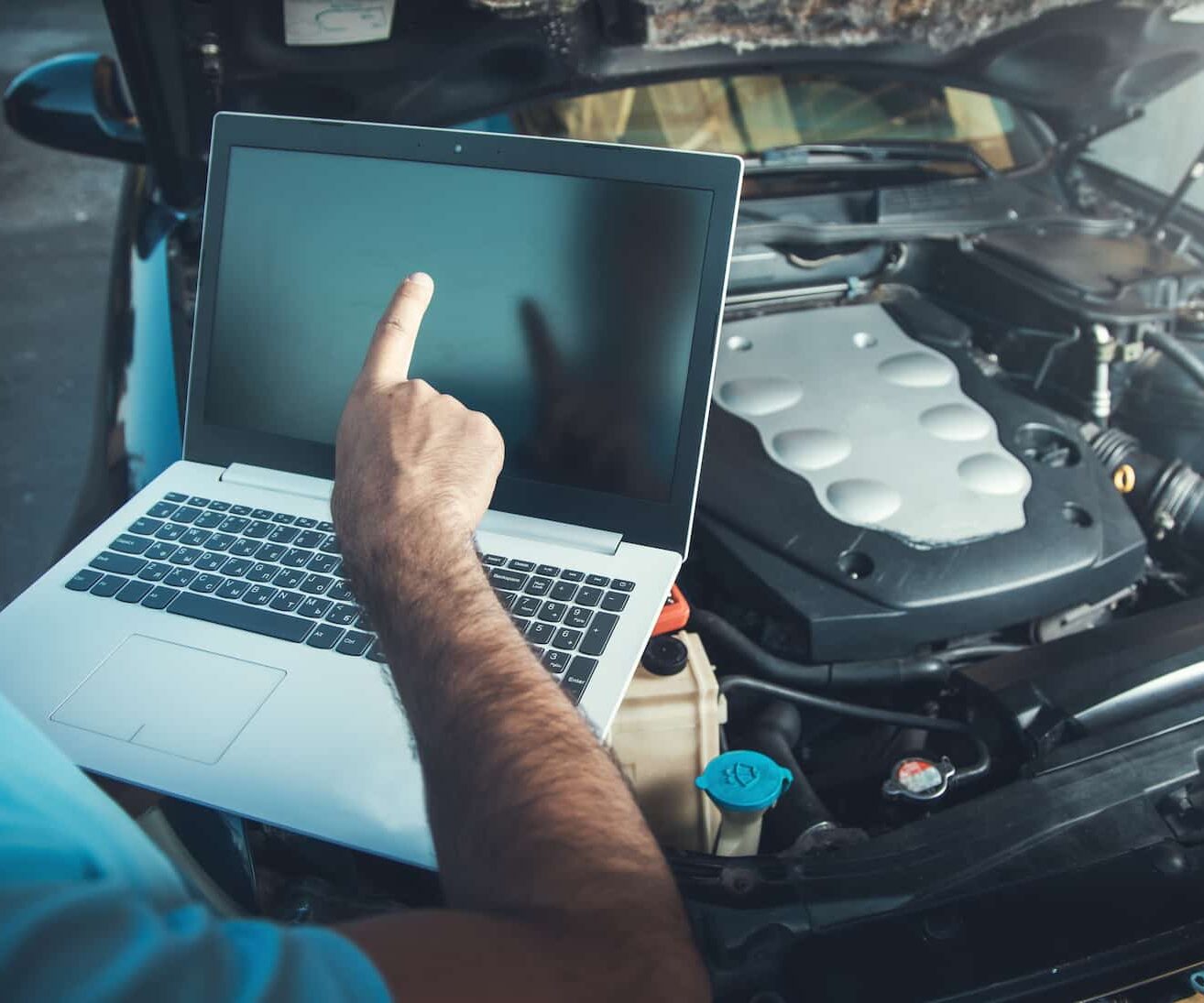 professional-car-mechanic-working-auto-repair-service-using-laptop-car (1)
